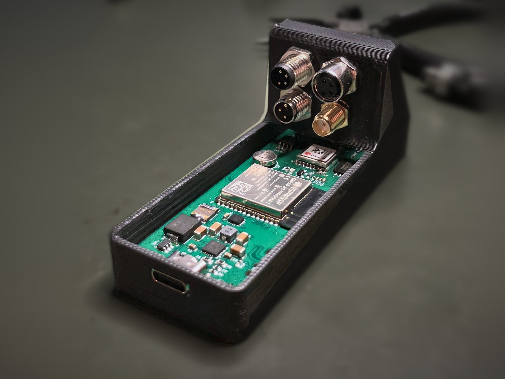 Open Agile v1.0 enclosure showing the circuit board with an ESP32-S3 module, a u-blox GNSS module and the connector panel