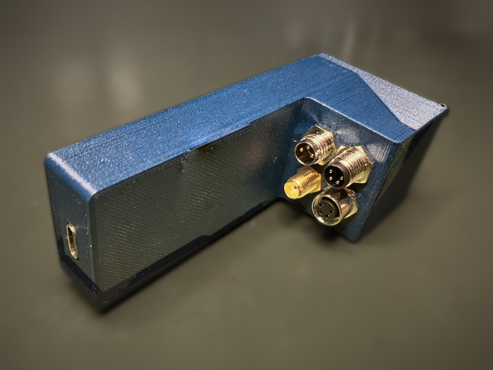 Rear of the Agile v1.0 enclosure with three circular connectors, an SMA antenna connector and a USB-C port at the end