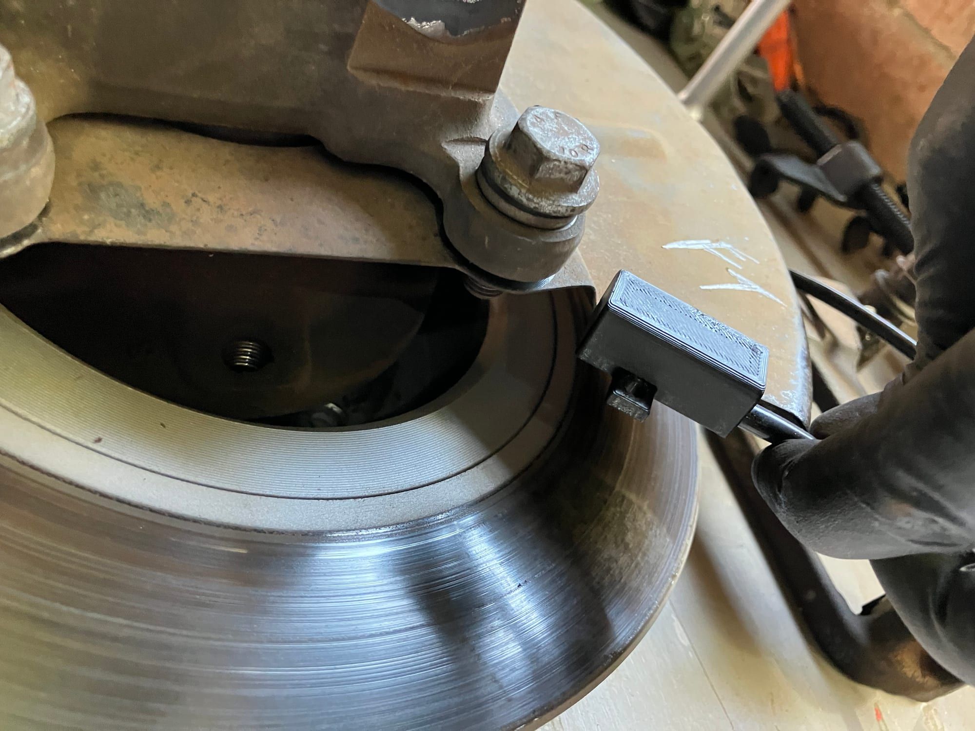 Infrared sensor node mounted next to a brake disc