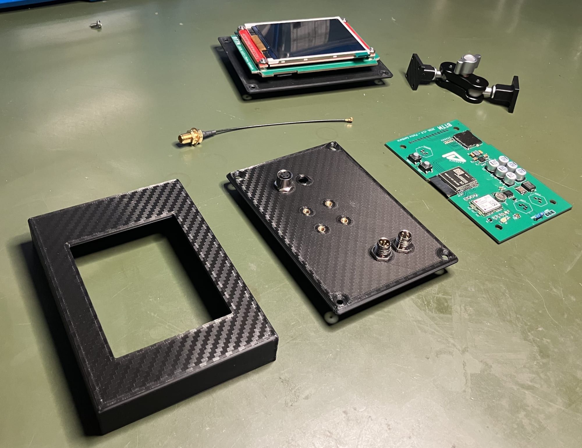 Sentinel main unit parts laid out before assembly, with the display, enclosure and main circuit board