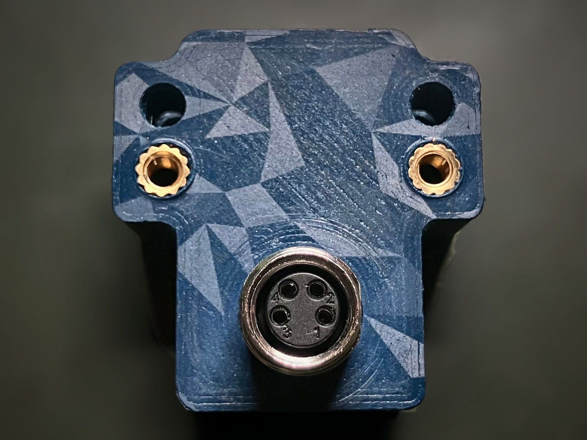 Iris v3.1 assembled in its blue 3D-printed enclosure, with brass threaded inserts and a 4-pin circular connector