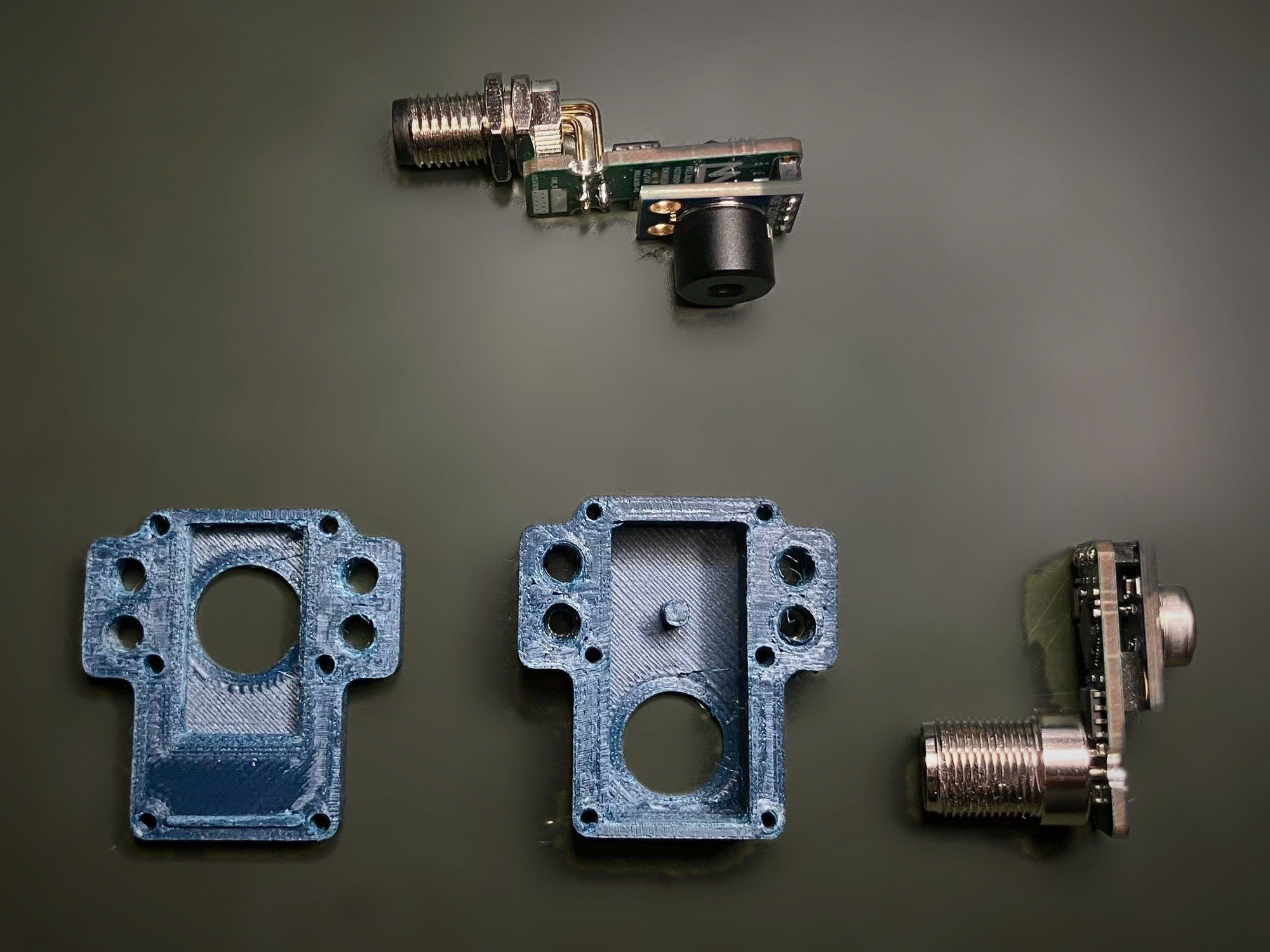 The two halves of the Iris v3.1 enclosure laid out next to two sensor boards